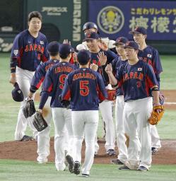 　巨人に逆転勝ちし、タッチを交わす日本代表ナイン＝東京ドーム