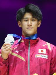 　体操の世界選手権の男子鉄棒で獲得した銀メダルを手にする橋本大輝＝６日、英リバプール（共同）