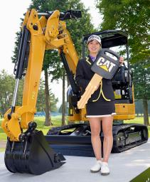 　優勝し、副賞の小型重機の前で写真に納まる蛭田みな美＝大箱根ＣＣ