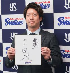 　契約更改交渉を終え、記者会見で来季の抱負を記した色紙を掲げるヤクルト・山田＝２８日、神宮球場