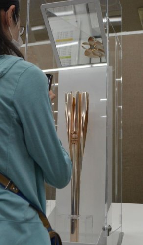 船橋市役所に展示された五輪聖火リレー用トーチ。鏡（上）が桜の花びらの形をした開口部を映し出す＝２４日
