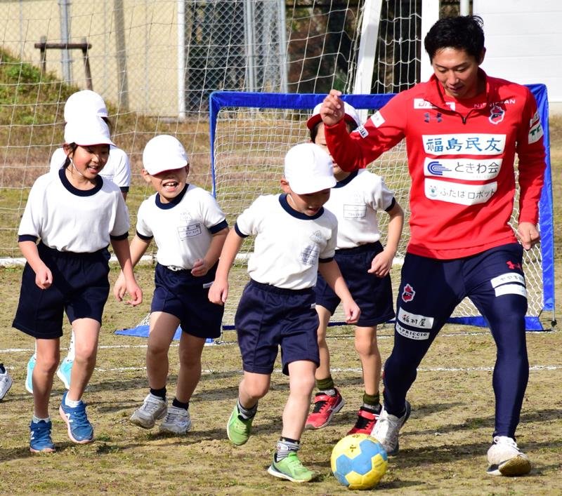 古川大悟選手とボールを追いかける児童＝茂原市立新治小