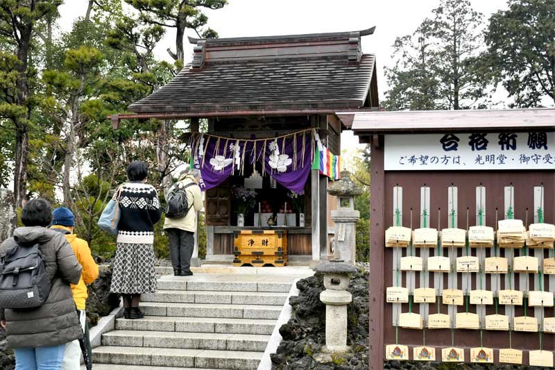 家族の学業成就などを願って成田山新勝寺の天満宮に手を合わせる参拝客ら＝２４日、成田市