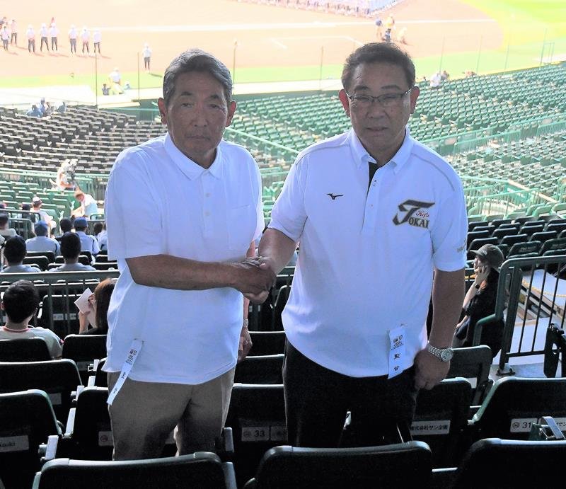 専大松戸の持丸監督（左）と握手する東海大甲府の村中監督＝甲子園

