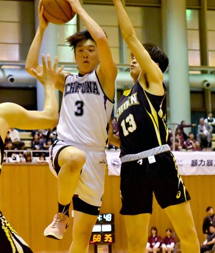 市船橋－八千代松陰　第３クオーター、ボールを持って競り合う市船橋の菊田（３）＝八千代市市民体育館