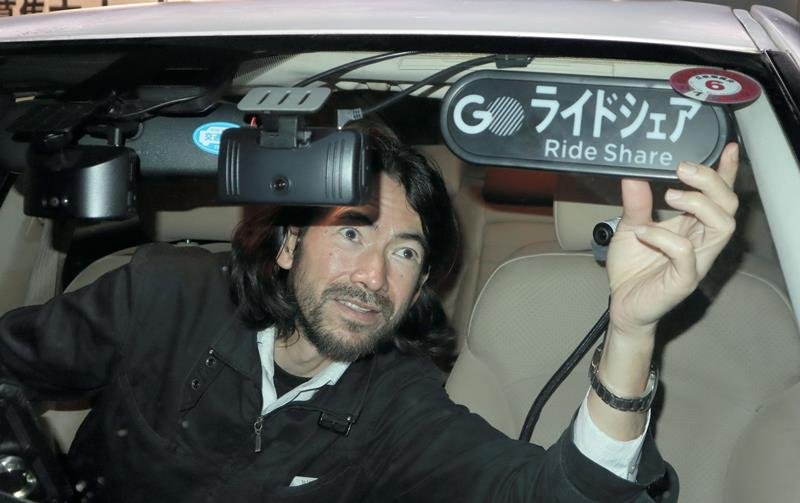 「ライドシェア」の表示灯を自家用車に取り付けるアゼベドさん＝千葉市中央区
